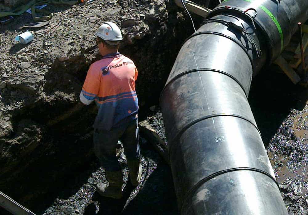 An image of a worker doing an inspection of a poly pipe