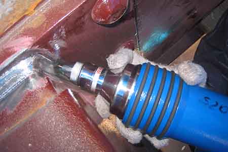 An image of the device used by a worker demonstrating Ultrasonic Peening