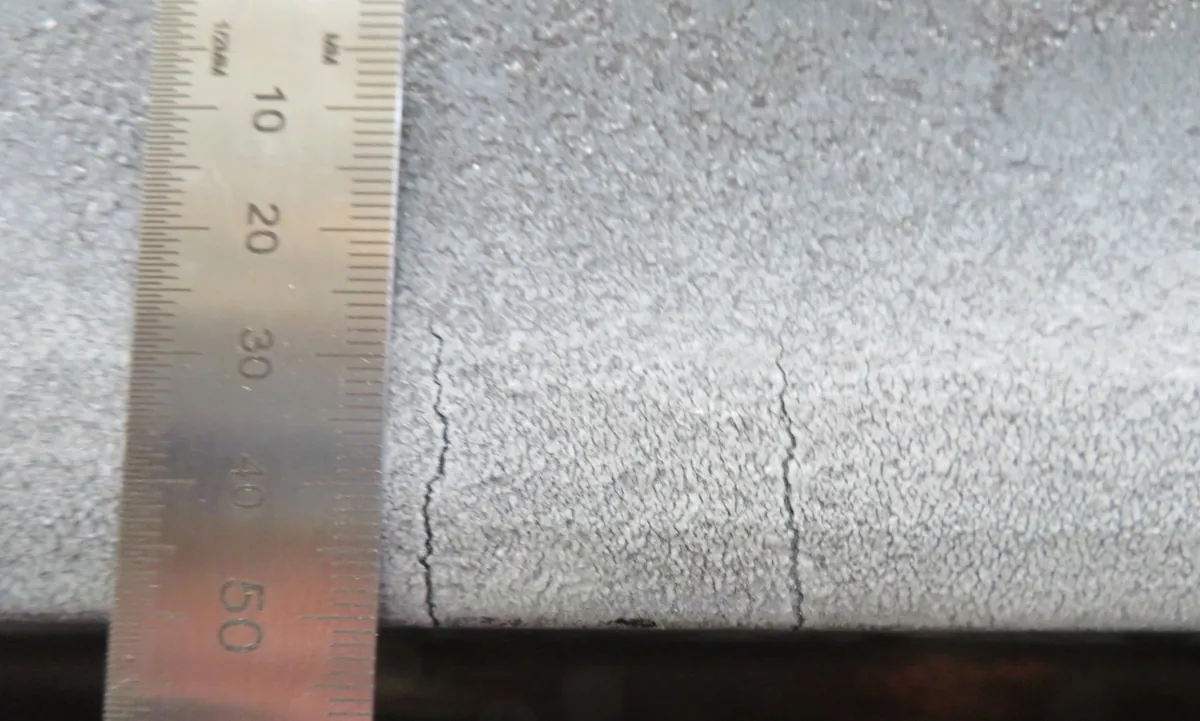 Transverse cracks in a weld face measured against a steel rule